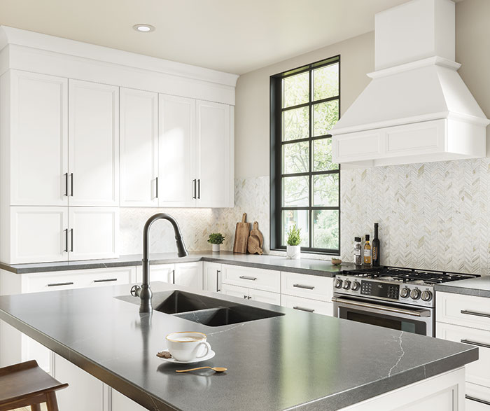 Bright white transitional kitchen with herringbone backsplash