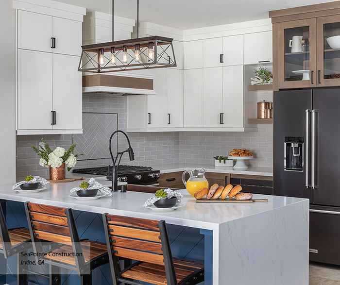 White and wood two-tone kitchen — quartz waterfall island