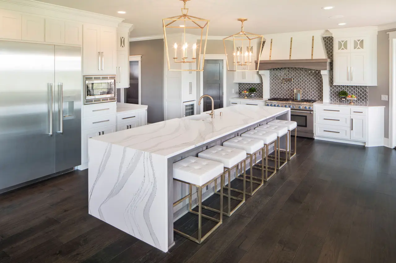 Cambria Brittanicca — grand white quartz island with gold pendants